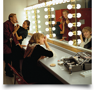 Actors in front of makeup mirror